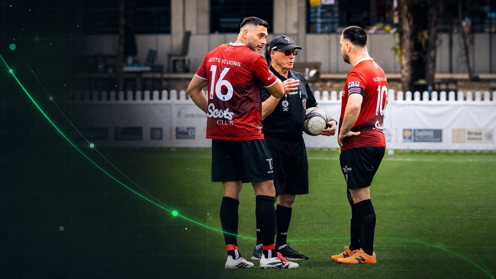 A football referee discusses an on-pitch ruling with two players.